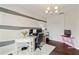 Spacious home office with multiple workstations, modern decor, and hardwood floors at 7730 Tiberon Pkwy, Cumming, GA 30028