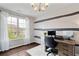 Bright home office with natural light, modern decor, and a functional workspace at 7730 Tiberon Pkwy, Cumming, GA 30028