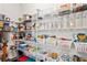 Organized pantry with wire shelving filled with an array of food items, snacks, and storage containers at 7730 Tiberon Pkwy, Cumming, GA 30028