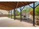 Covered patio area offering shade and a view of the backyard with play equipment and a lush garden at 7730 Tiberon Pkwy, Cumming, GA 30028