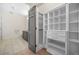 Bathroom featuring custom closet, vanity with dark cabinets, and tile floors at 1100 Howell Mill Nw Rd # 505, Atlanta, GA 30318