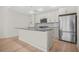 Modern kitchen with stainless steel appliances, center island, and stylish subway tile backsplash at 1100 Howell Mill Nw Rd # 505, Atlanta, GA 30318