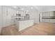 Modern kitchen with a central island, stainless steel appliances, and an open living area at 1100 Howell Mill Nw Rd # 505, Atlanta, GA 30318