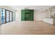 Spacious open floor plan with modern green built-ins, balcony and sleek countertops in the adjacent kitchen at 1100 Howell Mill Nw Rd # 505, Atlanta, GA 30318