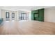 Expansive living room featuring hardwood floors, a ceiling fan, and custom green built-in at 1100 Howell Mill Nw Rd # 505, Atlanta, GA 30318