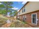 View of the backyard with a brick exterior and grassy area near standing water at 3162 Citrus Ct, Decatur, GA 30034