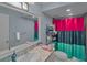 Bright bathroom features a large mirror, single vanity, and shower with vibrant curtains at 3162 Citrus Ct, Decatur, GA 30034