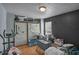 Cluttered bedroom with an exercise bike, a closet with hanging clothes and a window providing natural light at 3162 Citrus Ct, Decatur, GA 30034