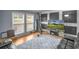 Spacious living room with hardwood floors, area rug, leather sofa, and a television for relaxing entertainment at 3162 Citrus Ct, Decatur, GA 30034