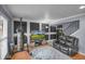 Well-lit living room features hardwood floors, a modern TV, punching bag, and a comfortable leather sofa at 3162 Citrus Ct, Decatur, GA 30034