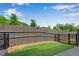 A well-maintained backyard features a grass area, a wooden fence, and a black iron fence at 355 Niles Ct # 2, Marietta, GA 30060