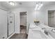 Bright bathroom featuring double sinks, a large mirror, glass shower, and walk-in closet at 355 Niles Ct # 2, Marietta, GA 30060