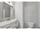Bright powder room featuring a white vanity, framed mirror, updated faucet, and new toilet at 355 Niles Ct # 2, Marietta, GA 30060