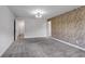 Bedroom with brick accent wall, carpet floors, updated lighting, and access to a bathroom at 355 Niles Ct # 2, Marietta, GA 30060