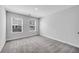 Bright bedroom with neutral gray walls, plush carpet, and two windows that let in natural light at 355 Niles Ct # 2, Marietta, GA 30060