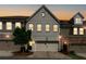 Charming townhome features a painted brick facade and attached garage at dusk at 355 Niles Ct # 2, Marietta, GA 30060