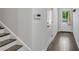 Light-filled hallway with hardwood floors, staircase, and access to the exterior at 355 Niles Ct # 2, Marietta, GA 30060
