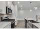 Modern kitchen featuring a gas range, stainless steel appliances, and island with sink at 355 Niles Ct # 2, Marietta, GA 30060