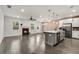 Open-concept living space with fireplace, hardwood floors, kitchen island and stainless appliances at 355 Niles Ct # 2, Marietta, GA 30060