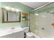 Well-lit bathroom with updated fixtures, a glass shower, and a decorative mirror at 4418 Chowning Way, Dunwoody, GA 30338