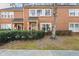 Brick townhomes with well-maintained landscaping and mature trees at 4418 Chowning Way, Dunwoody, GA 30338