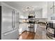Well-lit kitchen featuring granite counters, stainless steel appliances, and white cabinetry at 4418 Chowning Way, Dunwoody, GA 30338