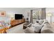 Comfortable living room with hardwood floors, large sofa, and modern entertainment center at 4418 Chowning Way, Dunwoody, GA 30338