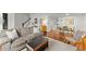 Open-concept living room with cozy seating, hardwood floors, and view of entryway at 4418 Chowning Way, Dunwoody, GA 30338
