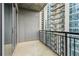 The balcony features black metal railings and views of a neighboring high-rise at 222 12Th Ne St # 1508, Atlanta, GA 30309