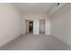 Spacious bedroom with neutral carpeting featuring access to bathroom and walk-in closet at 222 12Th Ne St # 1508, Atlanta, GA 30309