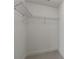 Walk-in closet featuring neutral carpet, angled walls, and metal rack shelving at 222 12Th Ne St # 1508, Atlanta, GA 30309