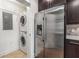 Convenient laundry room featuring stainless steel appliances and stackable washer/dryer at 222 12Th Ne St # 1508, Atlanta, GA 30309