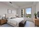 Bright bedroom featuring large window with city view, bed, and decor at 222 12Th Ne St # 1508, Atlanta, GA 30309