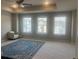 Large bedroom with tray ceilings, neutral walls, and large windows with a patterned rug at 243 Beau St, Lilburn, GA 30047
