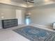 Spacious bedroom features a patterned rug, neutral walls, and ample natural light at 243 Beau St, Lilburn, GA 30047
