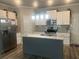 Stylish kitchen with white cabinets, stainless steel appliances and a gray backsplash at 243 Beau St, Lilburn, GA 30047