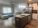 Open-concept kitchen featuring a center island and stainless steel appliances at 243 Beau St, Lilburn, GA 30047