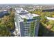 Gorgeous aerial view shows the rooftop of a glass condo building surrounded by lush greenery and neighborhood at 3300 Windy Ridge Se Pkwy # 1212, Atlanta, GA 30339