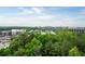 An aerial view shows the property with a backdrop of lush trees and a vibrant cityscape at 3300 Windy Ridge Se Pkwy # 1212, Atlanta, GA 30339