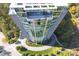 Unique aerial view of a glass condo building surrounded by greenery, a circular drive, and a rooftop patio at 3300 Windy Ridge Se Pkwy # 1212, Atlanta, GA 30339