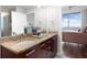 Bathroom featuring a double vanity with granite countertops and a bedroom view at 3300 Windy Ridge Se Pkwy # 1212, Atlanta, GA 30339