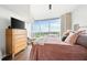 Bright bedroom with large window view, comfortable bed, and wooden dresser at 3300 Windy Ridge Se Pkwy # 1212, Atlanta, GA 30339