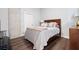 Cozy bedroom with a wood-framed bed, hardwood floors, and neutral decor at 3300 Windy Ridge Se Pkwy # 1212, Atlanta, GA 30339