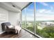 Relaxing bedroom seating area with floor-to-ceiling windows and scenic views at 3300 Windy Ridge Se Pkwy # 1212, Atlanta, GA 30339