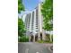 Modern high-rise condo building featuring balconies and landscaped entrance at 3300 Windy Ridge Se Pkwy # 1212, Atlanta, GA 30339