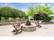 Outdoor fire pit with lounge seating on a stone patio, surrounded by trees at 3300 Windy Ridge Se Pkwy # 1212, Atlanta, GA 30339
