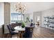 Bright, open living room with a modern chandelier, dining area, and large windows offering natural light and great views at 3300 Windy Ridge Se Pkwy # 1212, Atlanta, GA 30339