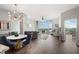 Bright, open living room featuring a modern chandelier, dining area, and large windows with scenic views at 3300 Windy Ridge Se Pkwy # 1212, Atlanta, GA 30339