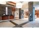 Hotel lobby with front desk, stone wall, and modern lighting at 3300 Windy Ridge Se Pkwy # 1212, Atlanta, GA 30339