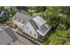 Aerial view of a charming home with a modern roof, complemented by lush landscaping and a serene neighborhood at 676 Juneberry Se Ln, Atlanta, GA 30316